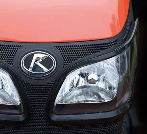 Close up image of orange Kubota tractor head light