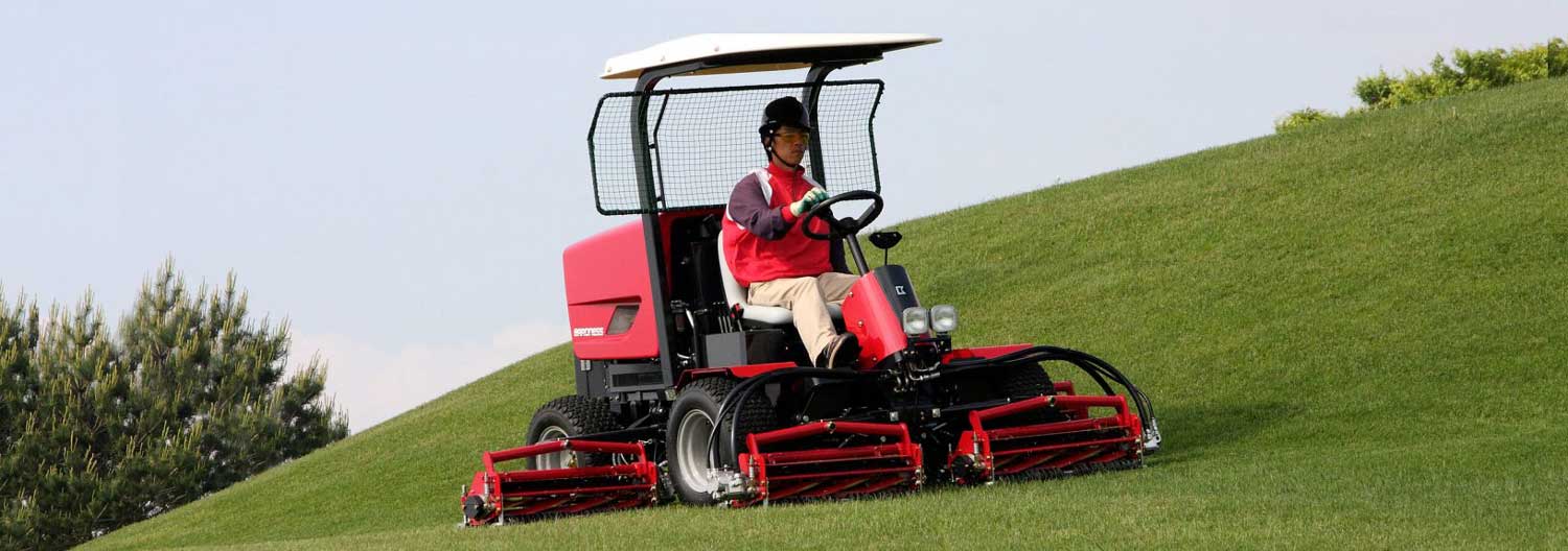 A man operating a LM331 trim mower on a open field.