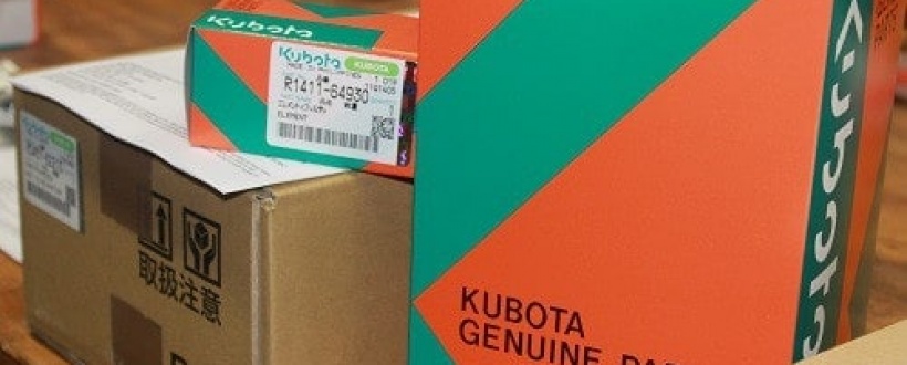 Kubota genuine parts in courier boxes piled on a table